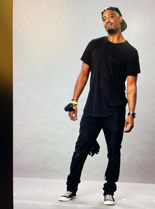 Cornell Agee standing in front of a white background at a photo shoot