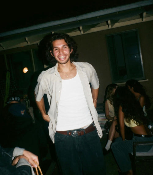 Erik Herrera smiling at a backyard party at night