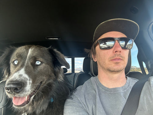 Tucker Watson and his dog in a car with a scenic background