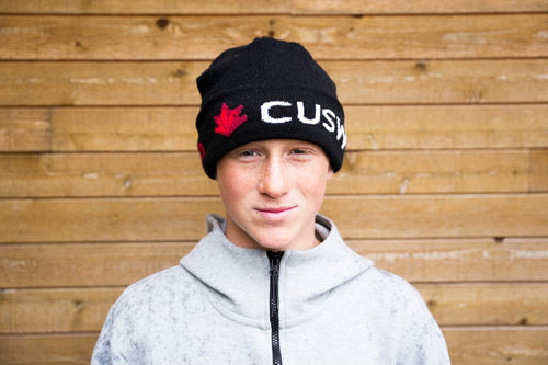 Tristan Day wearing a black beanie against a wooden background